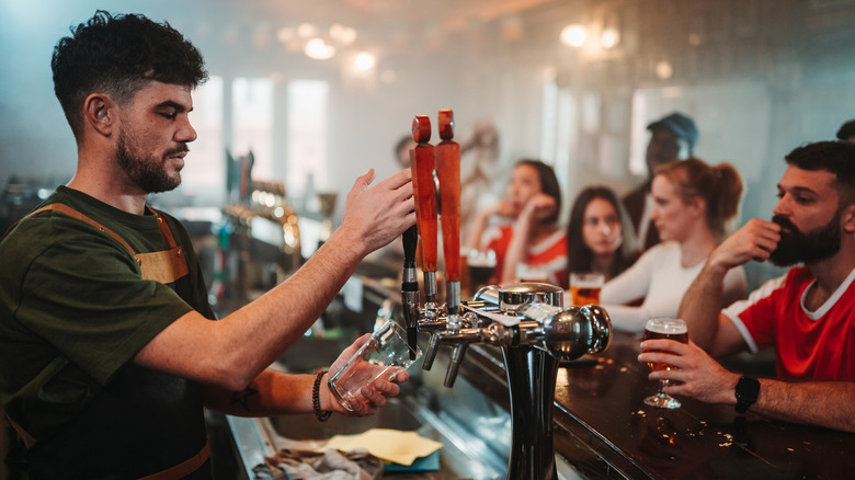 Bartender making drinks at busy bar