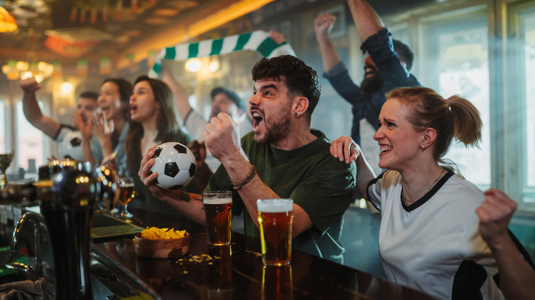 Patrons cheering at a spots bar