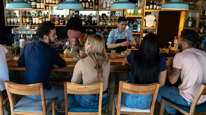 People sitting at a busy bar