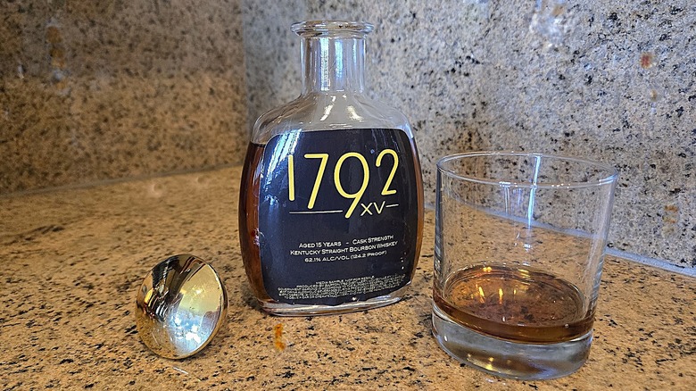 Open bottle of Barton 1792 XV with rocks glass
