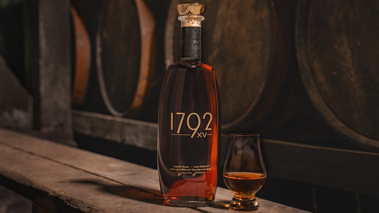 Beauty shot of Barton 1792 XV whiskey bottle and glass