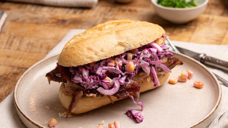 barbecue pork rib sandwich with slaw on plate
