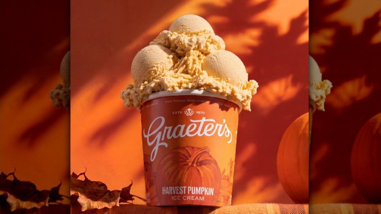 A pint of Graeter's Harvest Pumpkin ice cream in a festive fall background