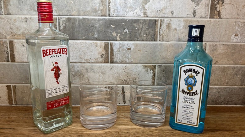 bottle of Beefeater gin next to bottle of Bombay Sapphire