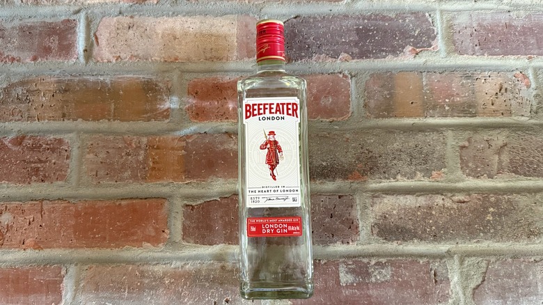 bottle of Beefeater dry gin on a brick floor