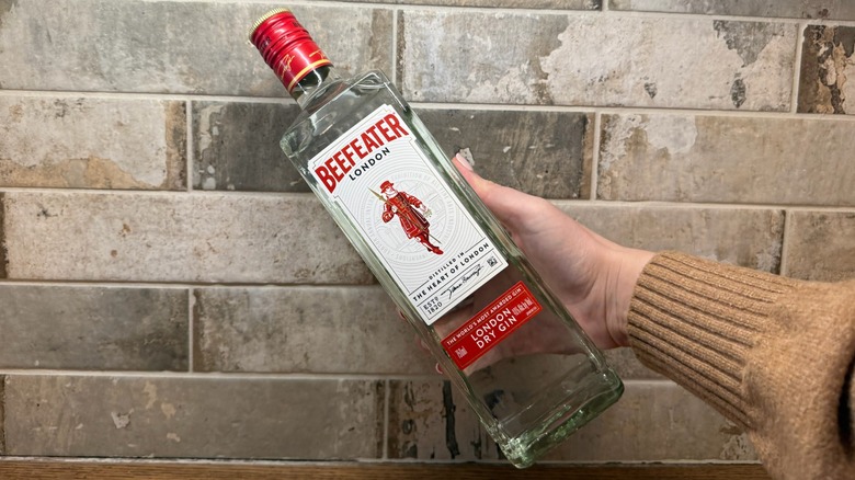 bottle of Beefeater gin being held up