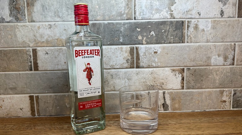 Beefeater gin bottle with a glass next to it