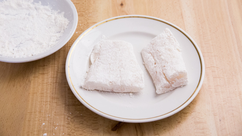 flour-coated cod on plate