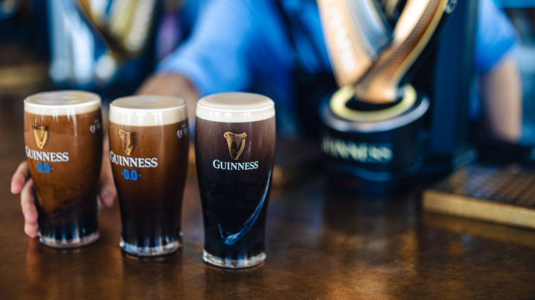 Three pints of Guinness beer on the counter of an Irish pub