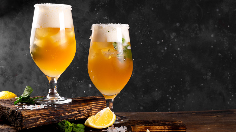 a couple of beer cocktails in hurricane glasses