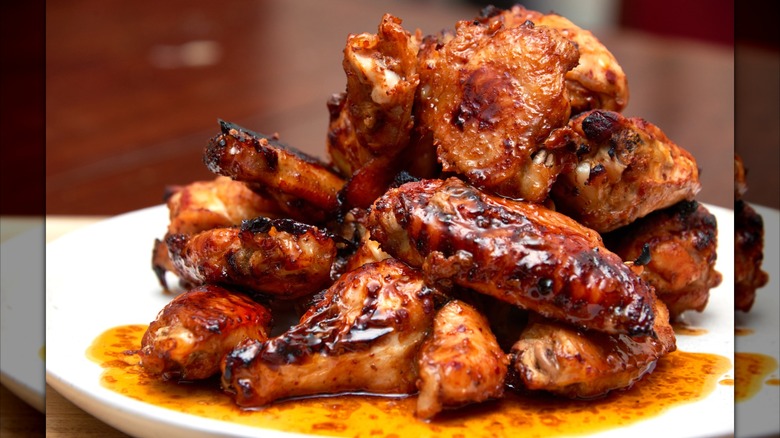 A plate of saucy chicken wings