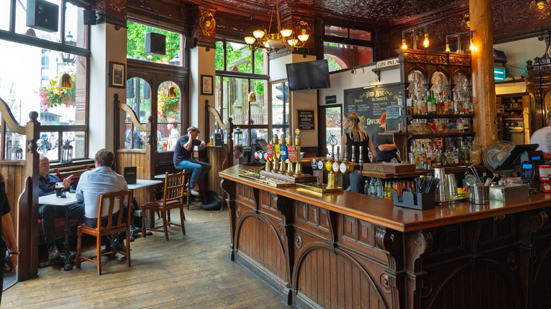 Interior of a London pub with a handful of customers