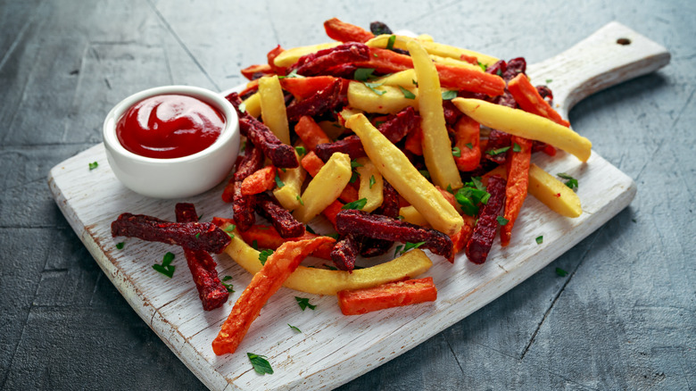 root vegetable fries with kethcup on a board