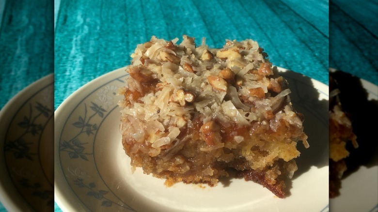 A piece of Texas Tornado cake on a white and blue plate