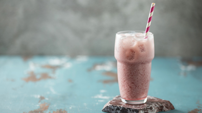 A creamy dirty soda with ice and straw