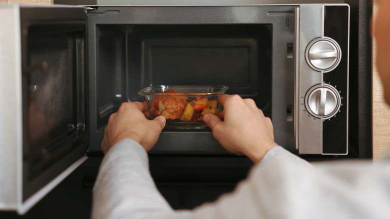 Foodie microwaving a container of food