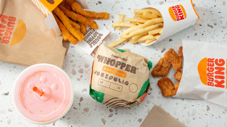 A variety of Burger King menu items laid out on a white stone countertop