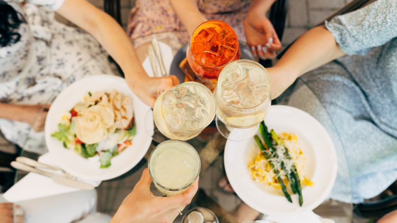 Friends toasting with cocktails