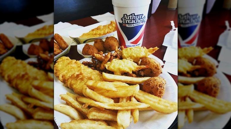 Arthur Treacher's Fish & Chips meal served on a paper plate next to a branded drink cup