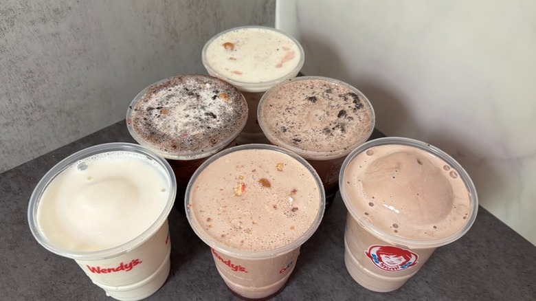 Various flavors of Wendy's Frosty in plastic cups