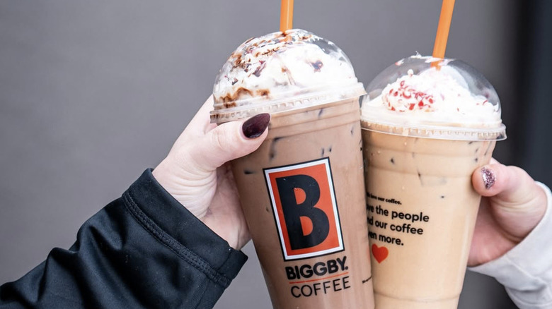 customers holding coffee drinks