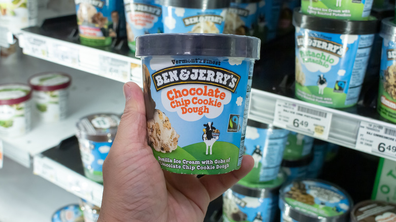 Someone holding a pint of cookie dough ice cream