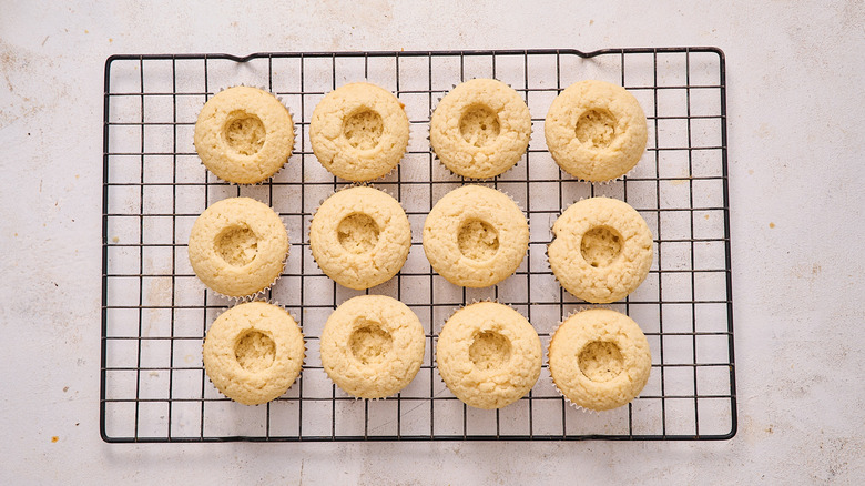 cored cupcakes on a wire rack