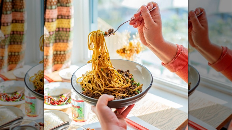 A person twirling classic noodle dish at Scrag and Roe restaurant in Vermont