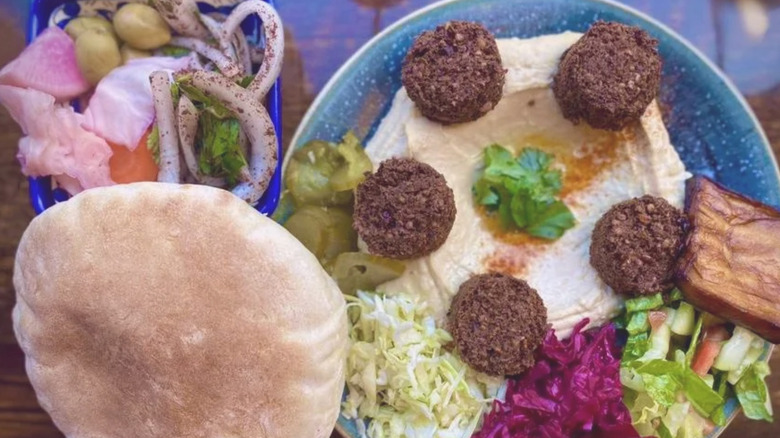 Top view of Yalla falafel bowl with fresh pita bread