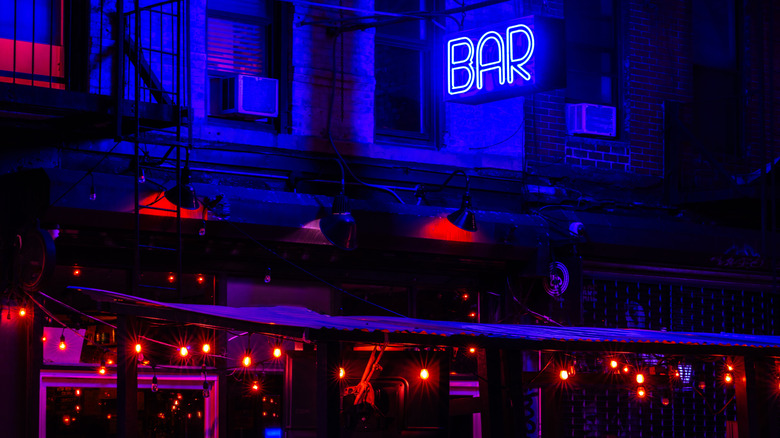 Blue neon bar sign in NYC at night