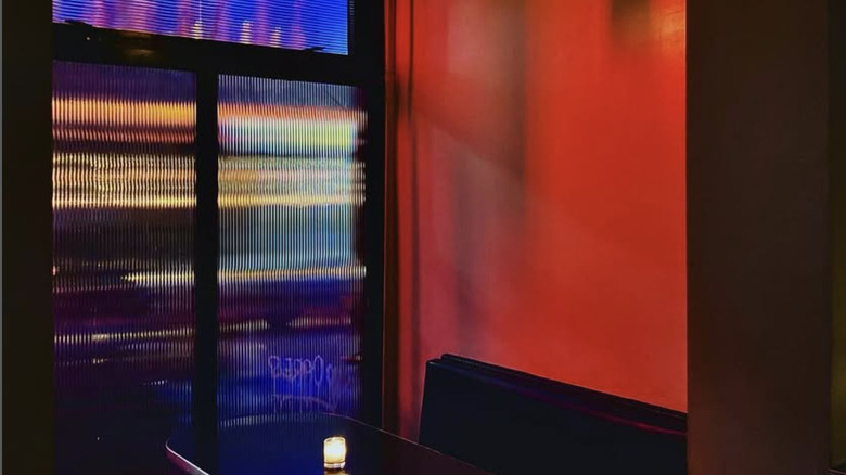 Red wall and booth at The Narrows bar