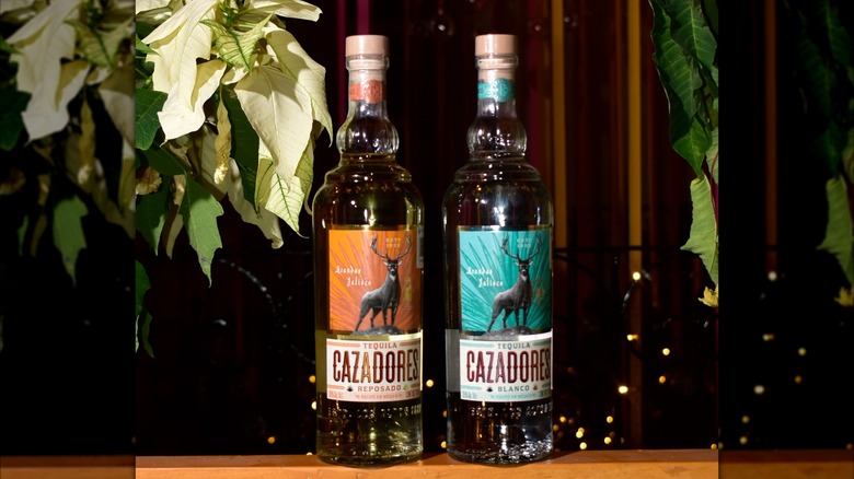 Bottles of Cazadores Tequila Blanco and Reposado with a poinsettia