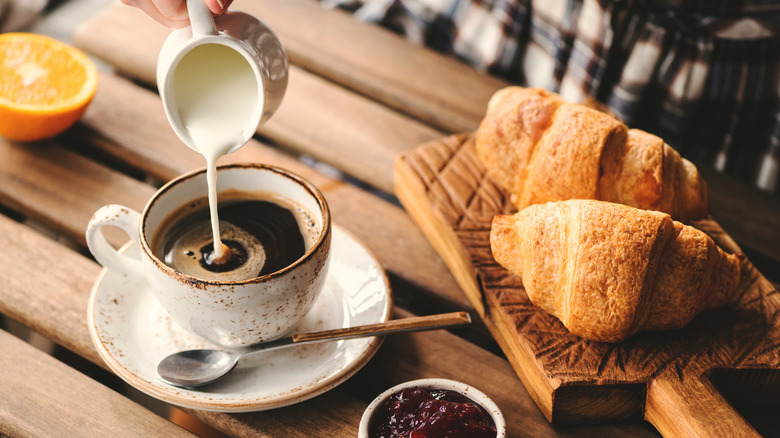puring creamer into coffee