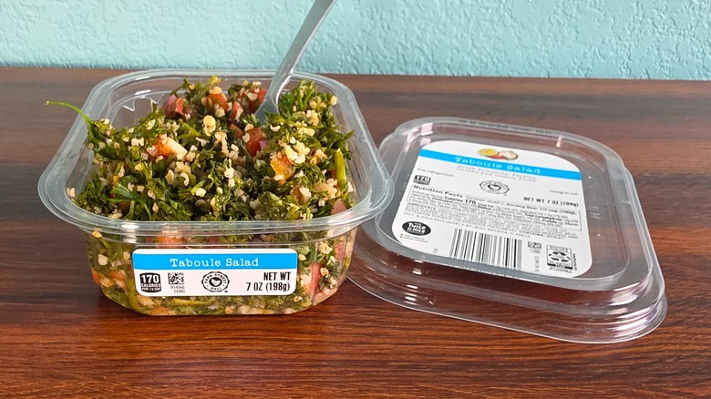 Park Street taboule salad on a wood table with a fork