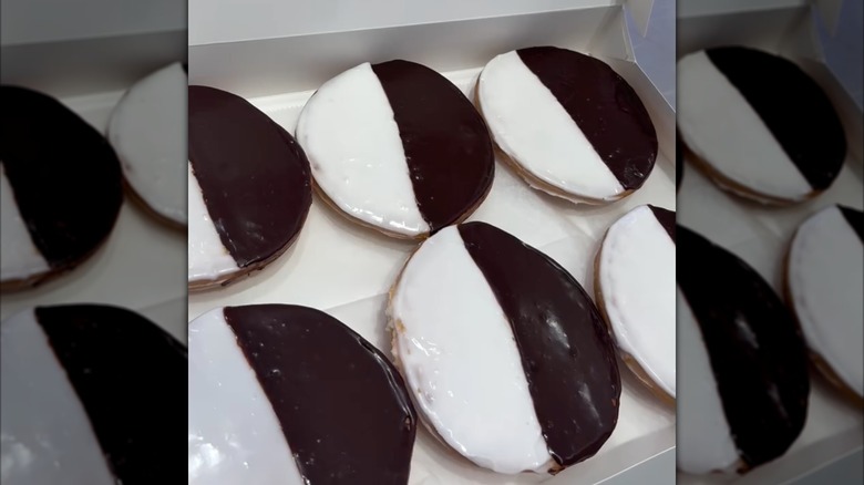 Six black and white cookies in a pastry box