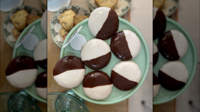 Overhead shot of six black and white cookies on a display plate