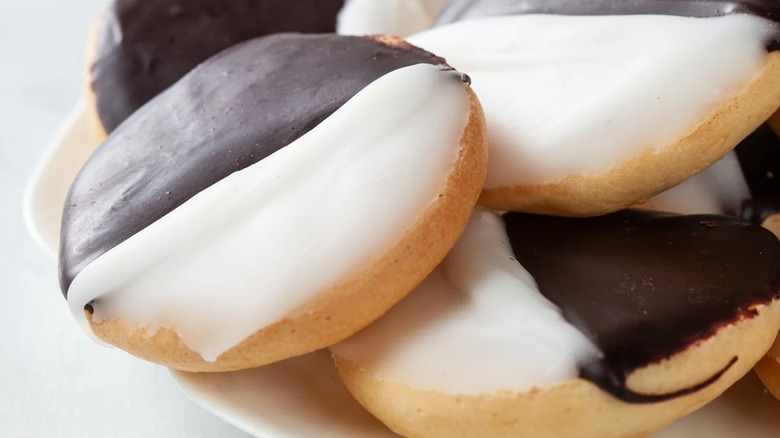Close-up of several black and white cookies on a plate