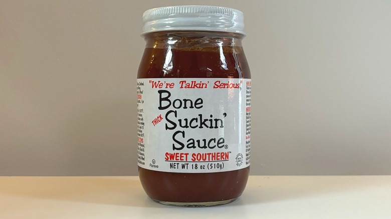 Jar of Bone Suckin' Sweet Southern BBQ sauce on white table