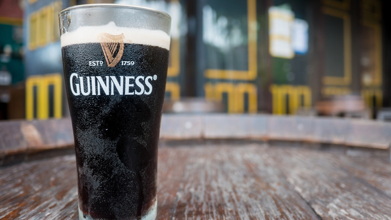 Glass of Guinness outside of a pub