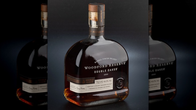 A bottle of Woodford Reserve Double Oaked against a neutral background