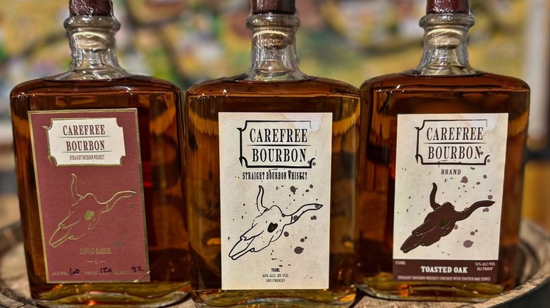 Three different bottles of Carefree Spirits bourbon