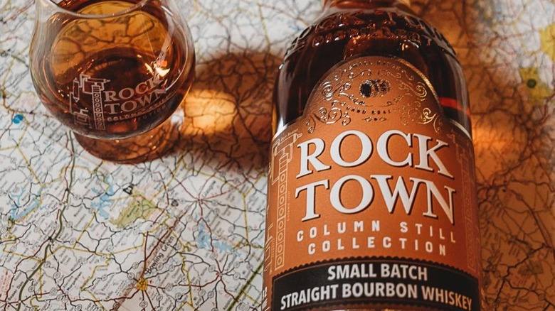 Bottle and glass of Rock Town bourbon on map