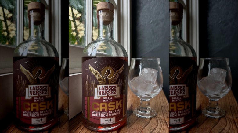 Bottle of Laissez Versez cask strength whiskey with glass and ice