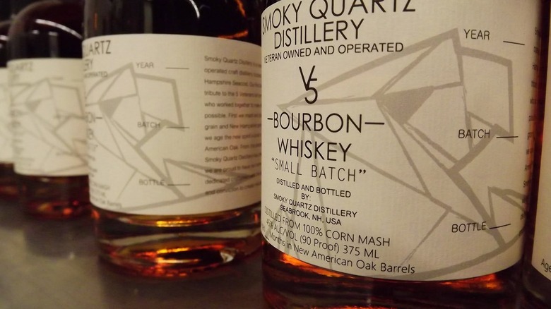 Several bottles of V5 bourbon with close-up on labels