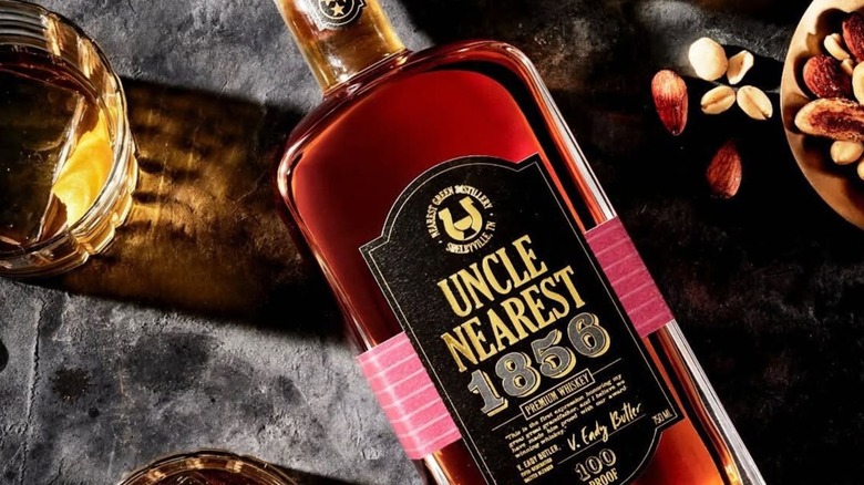 Bottle of Uncle nearest 1856 with peanuts and glass