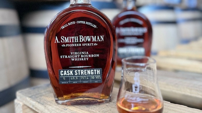 Bottle of cask strength bourbon with glass
