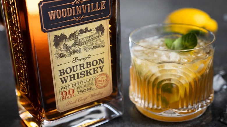 Bottle of Woodinville bourbon with cocktail