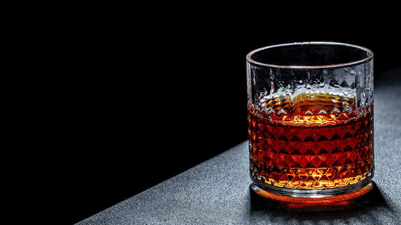 Glass of bourbon on a table