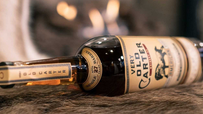 Old Carter bourbon bottle sideways on a table