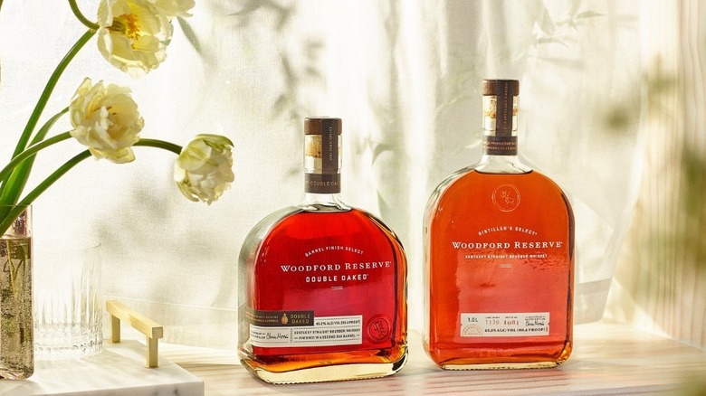 Woodford Reserve bourbon bottles next to flowers